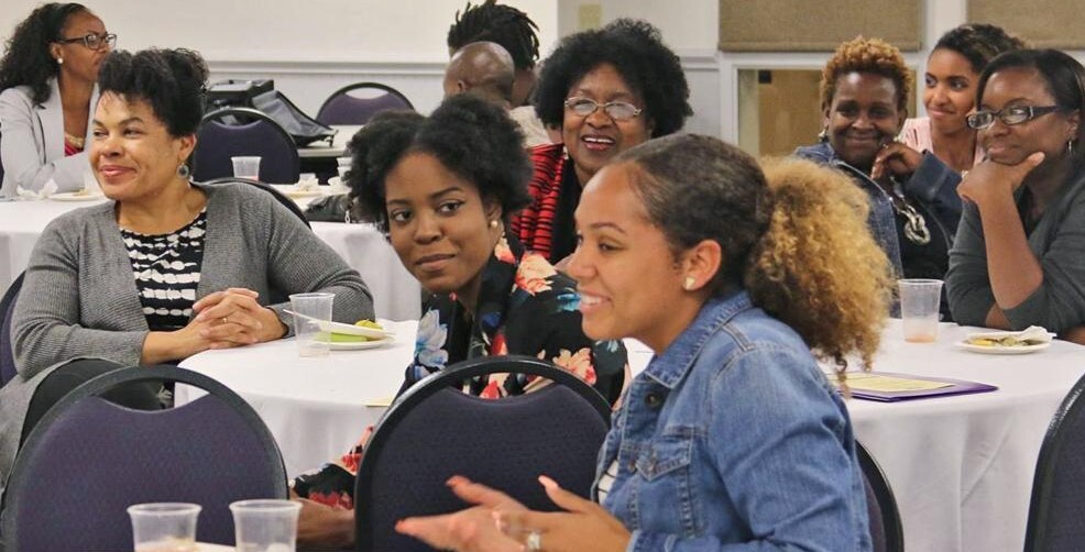 women sitting at round tables talking